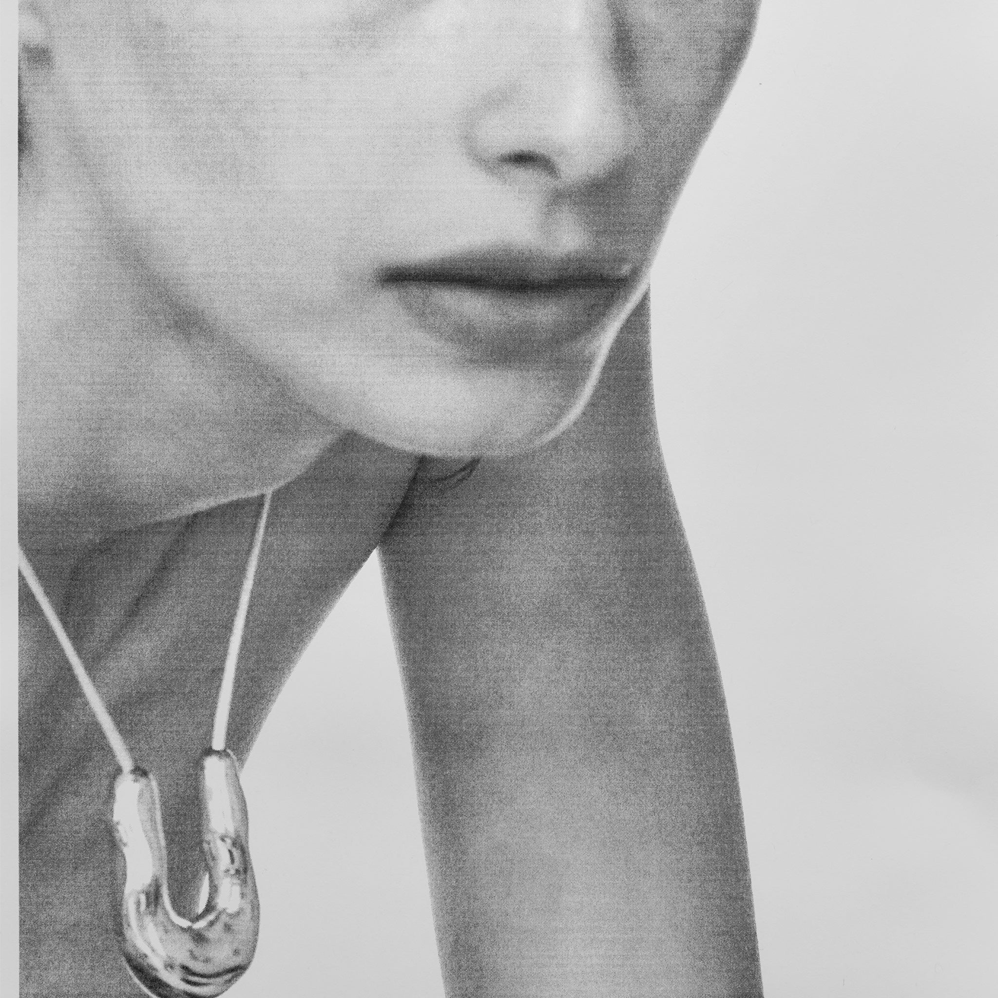 Person wearing AGMES .925 sterling silver wishbone pendant on Ivory Satin cord.