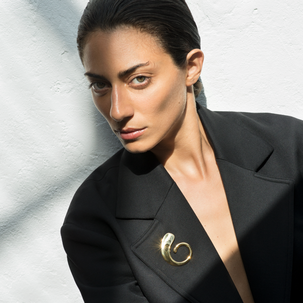 Woman wearing the AGMES 18K Gold Vermeil Marta Brooch on black blazer. 