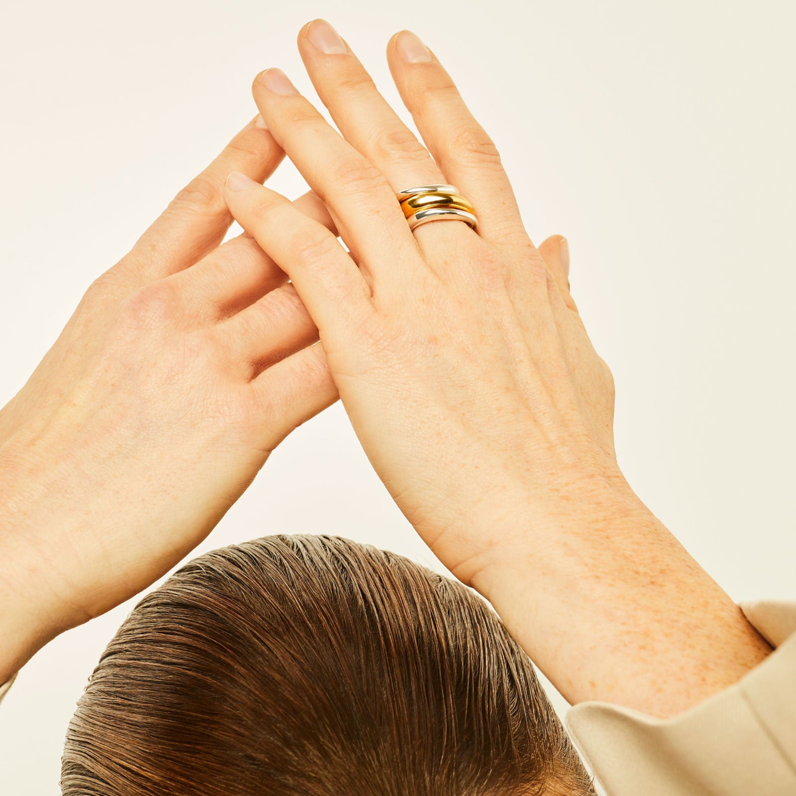 Hand wearing AGMES Astrid Ring Set III in .925 Sterling Silver, and 14k Solid Yellow Gold. Includes 2 medium, and 1 large Astrid Ring. 