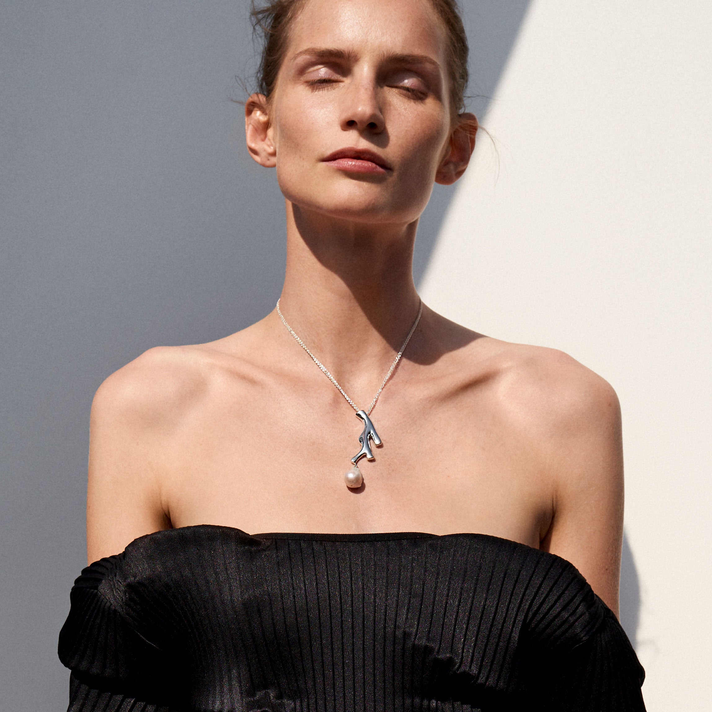 Woman wearing AGMES 0.925 sterling silver Coral drop Pendant with baroque freshwater pearl. 