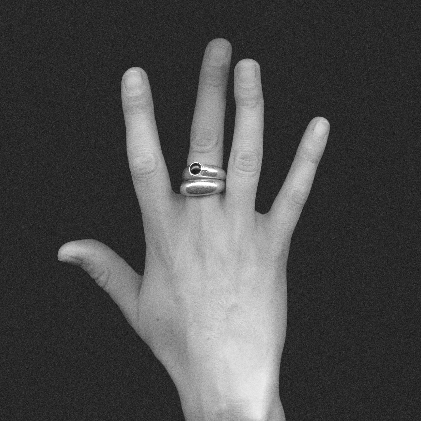 Hand wearing AGMES .925 Sterling Silver Cara Domed Ring Set with Onyx Stone Center. 