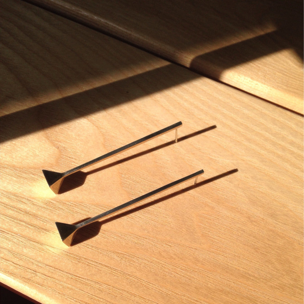 AGMES .925 sterling silver long thin Drop Earrings on wooden background.