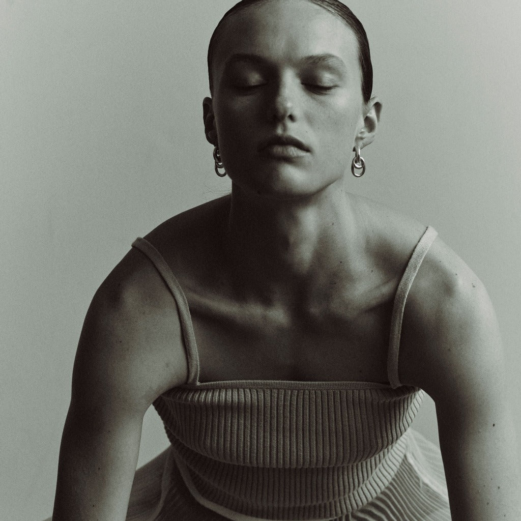 Woman wearing AGMES 0.925 sterling silver double drop hoop earrings.