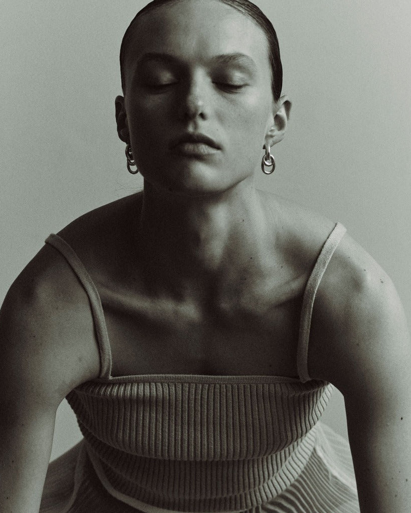 Woman wearing AGMES 0.925 sterling silver double drop hoop earrings.