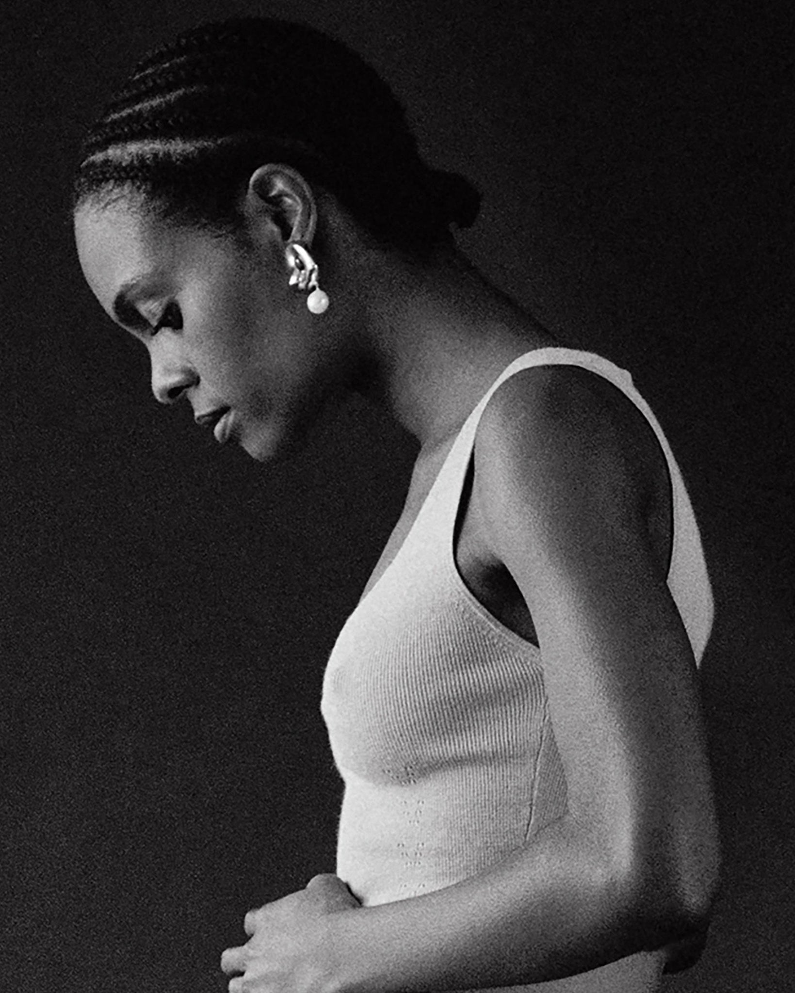 Woman wearing AGMES 0.925 sterling silver sculpted Gertrude pearl drop earrings. Simone Bodmer-Turner.