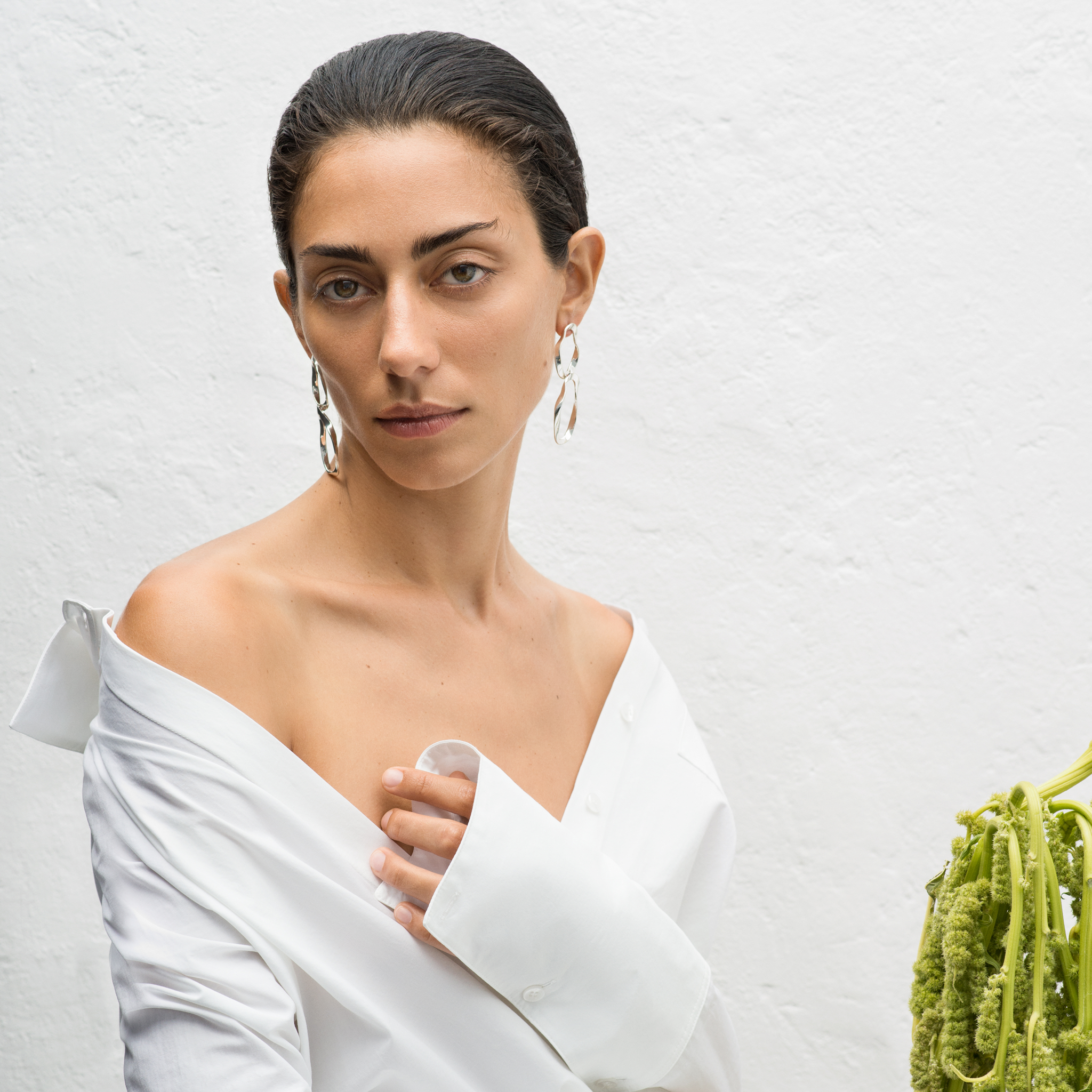 Woman wearing .925 sterling silver AGMES earrings with 2-tiered hoop design