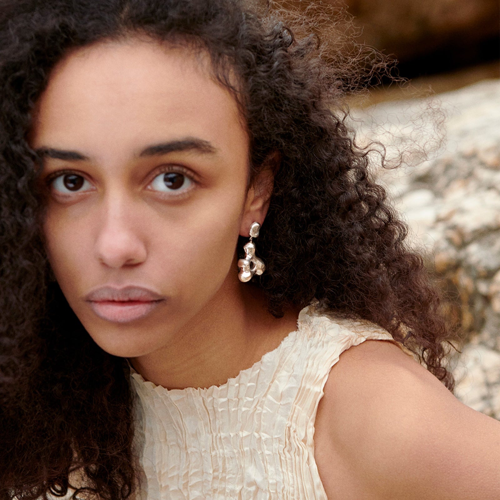 Woman wearing AGMES 0.925 sterling silver sculpted drop earrings. Simone Bodmer-Turner.