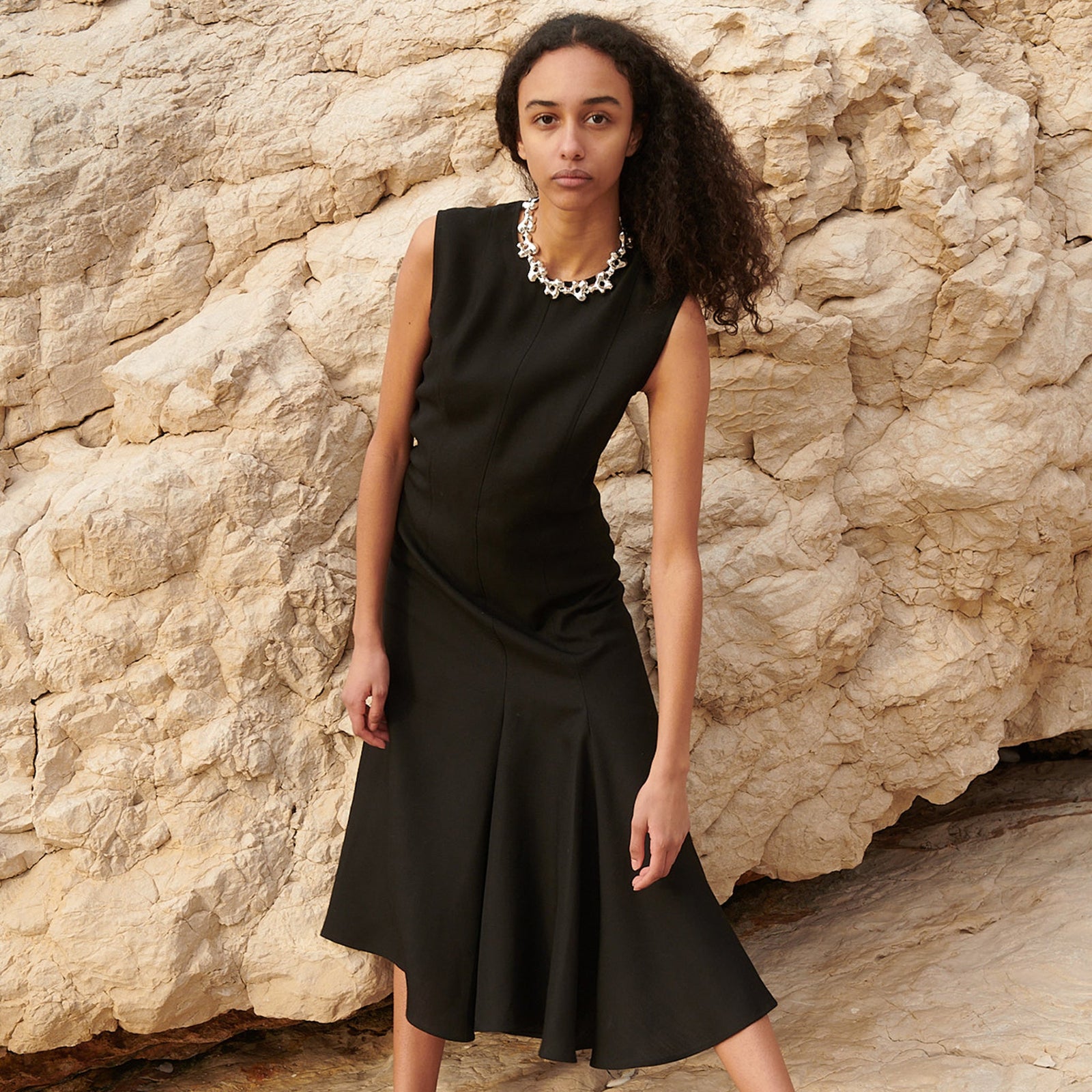 Model wearing AGMES .925 sterling silver sculptural collar Simone Necklace with black dress.