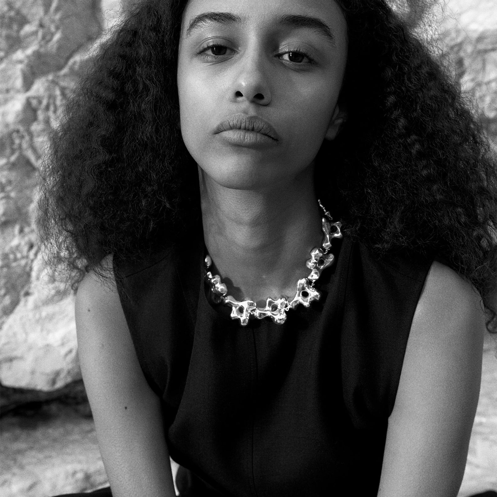 Model wearing AGMES .925 sterling silver sculptural collar Simone Necklace with black top.