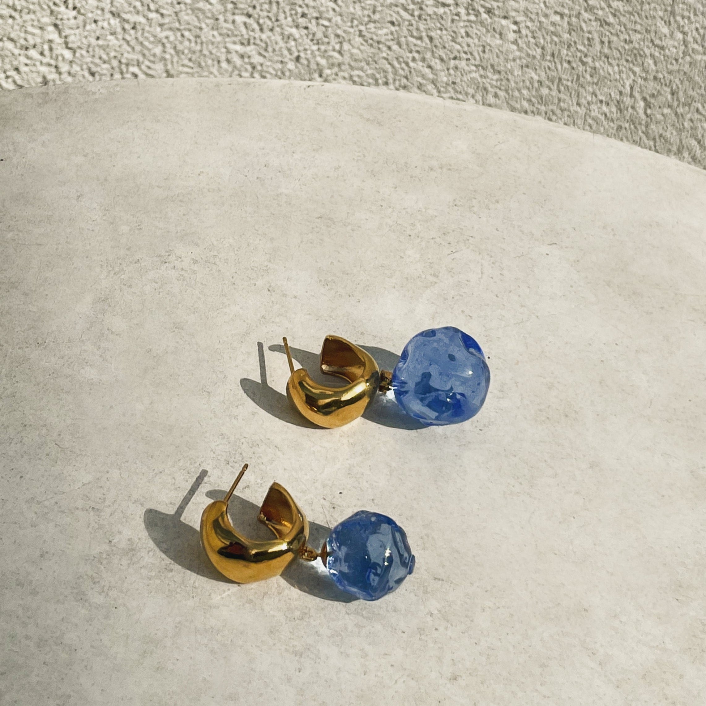 AGMES yellow gold vermeil small Cleo hoop earrings with blue glass beads.