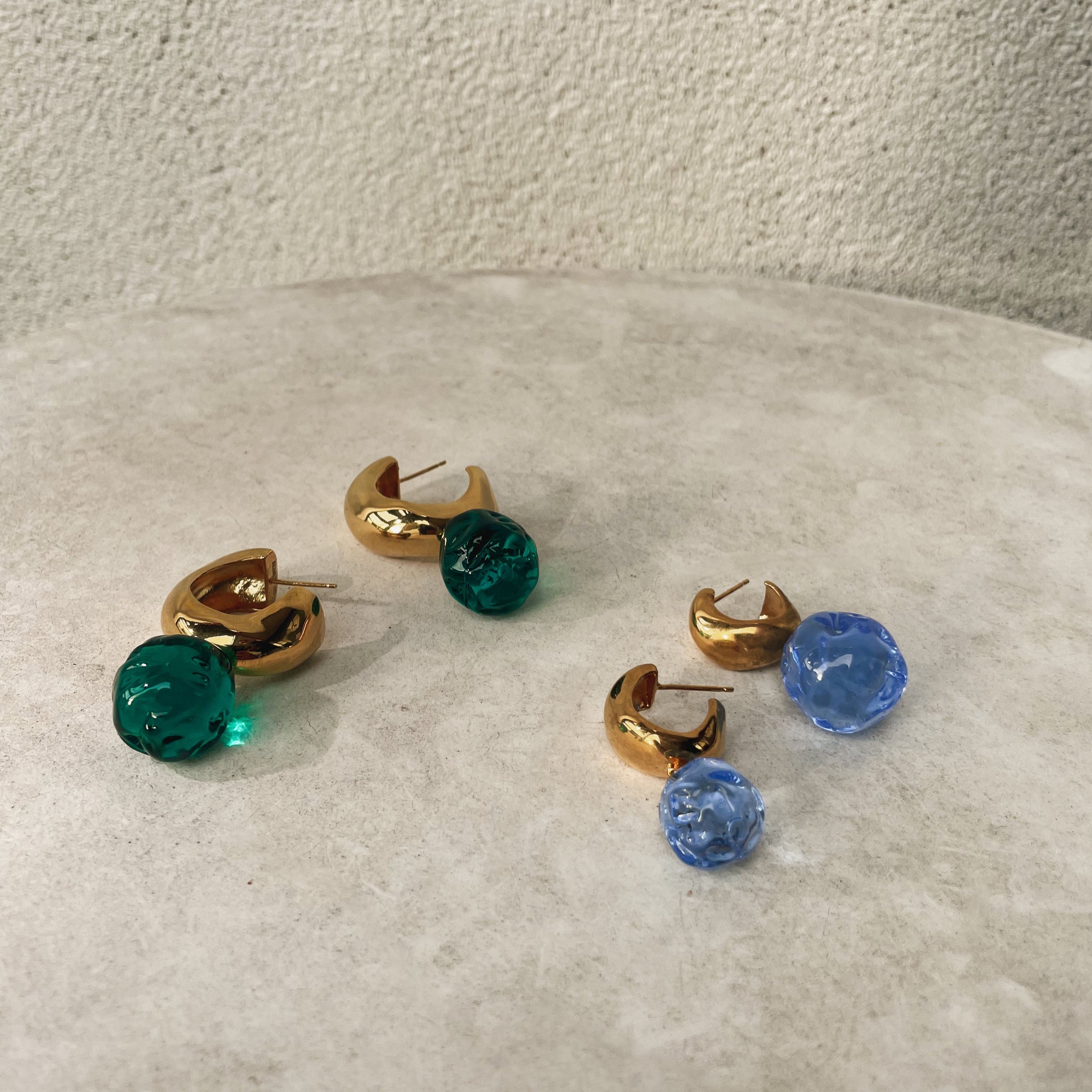 AGMES yellow gold vermeil small Cleo hoop earrings with blue and green glass beads.