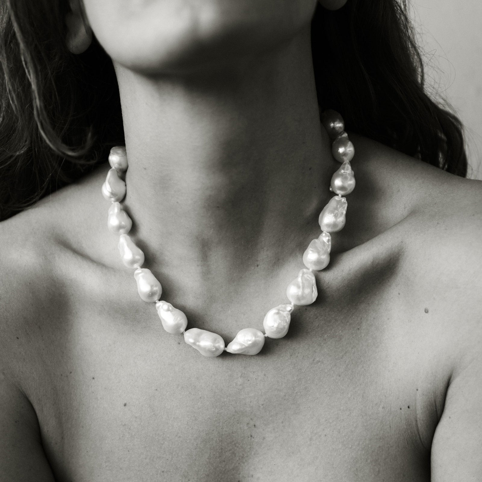 Model wearing AGMES freshwater Baroque Pearl Necklace. Black and white image.